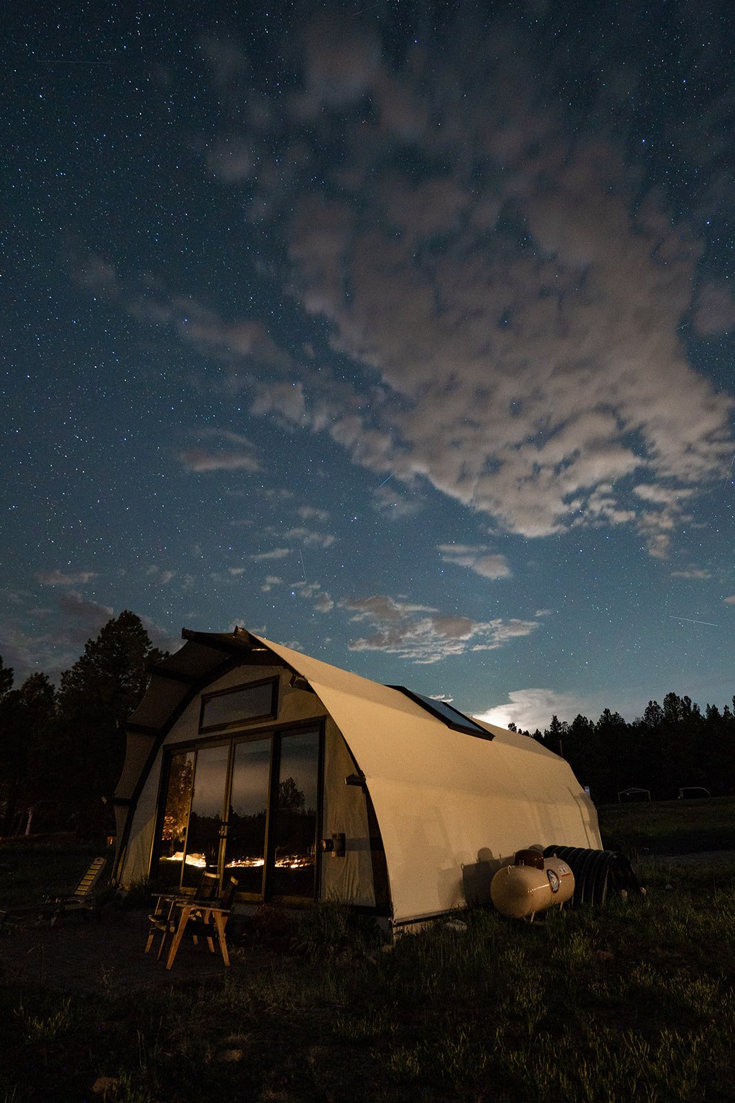 Stars above a warmly lit tent at Backland Luxury Nature Resort in Arizona
