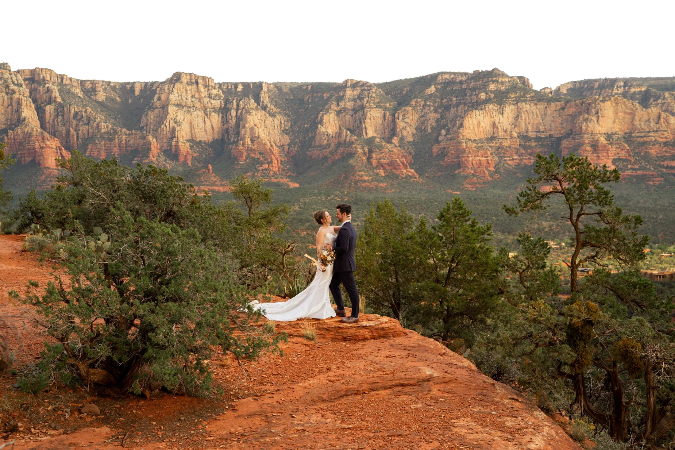 Sheridan and Ayrton on the red rocks at Airport Mesa with Sedona’s formations behind them