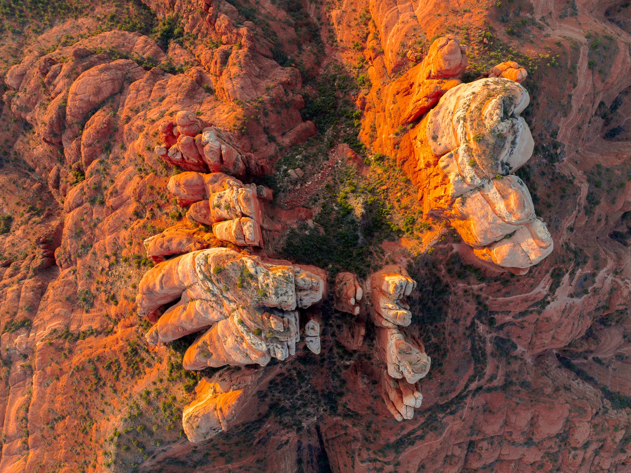 An aerial perspective of Cathedral Rock’s sandstone formations in golden light