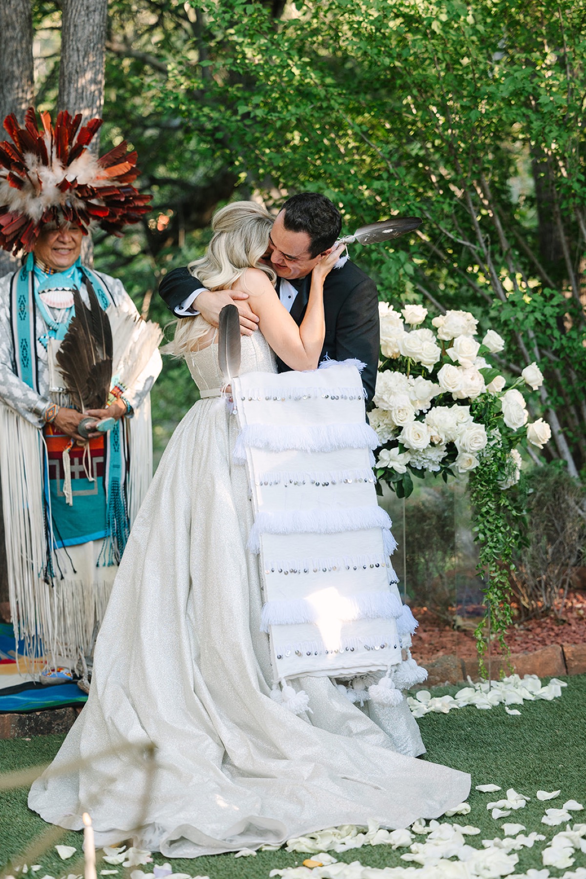 Shana and Kamal embracing at their outdoor wedding ceremony