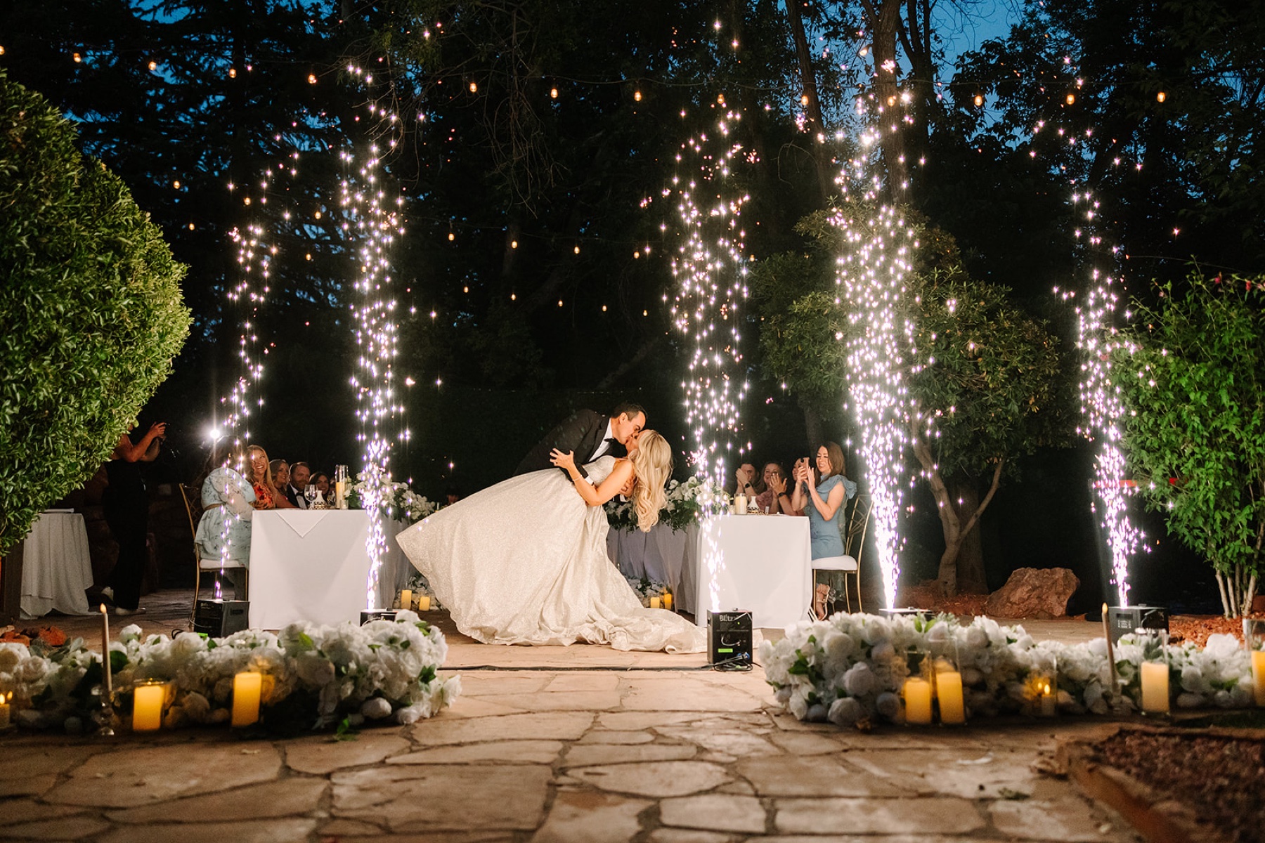 Shana and Kamal celebrating beneath sparkler fountains