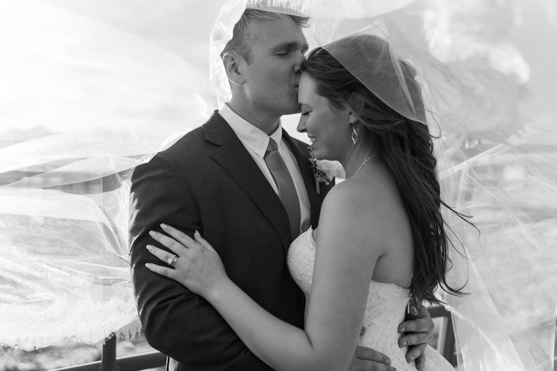 Taylor and Wesley beneath the veil, photographed in black and white