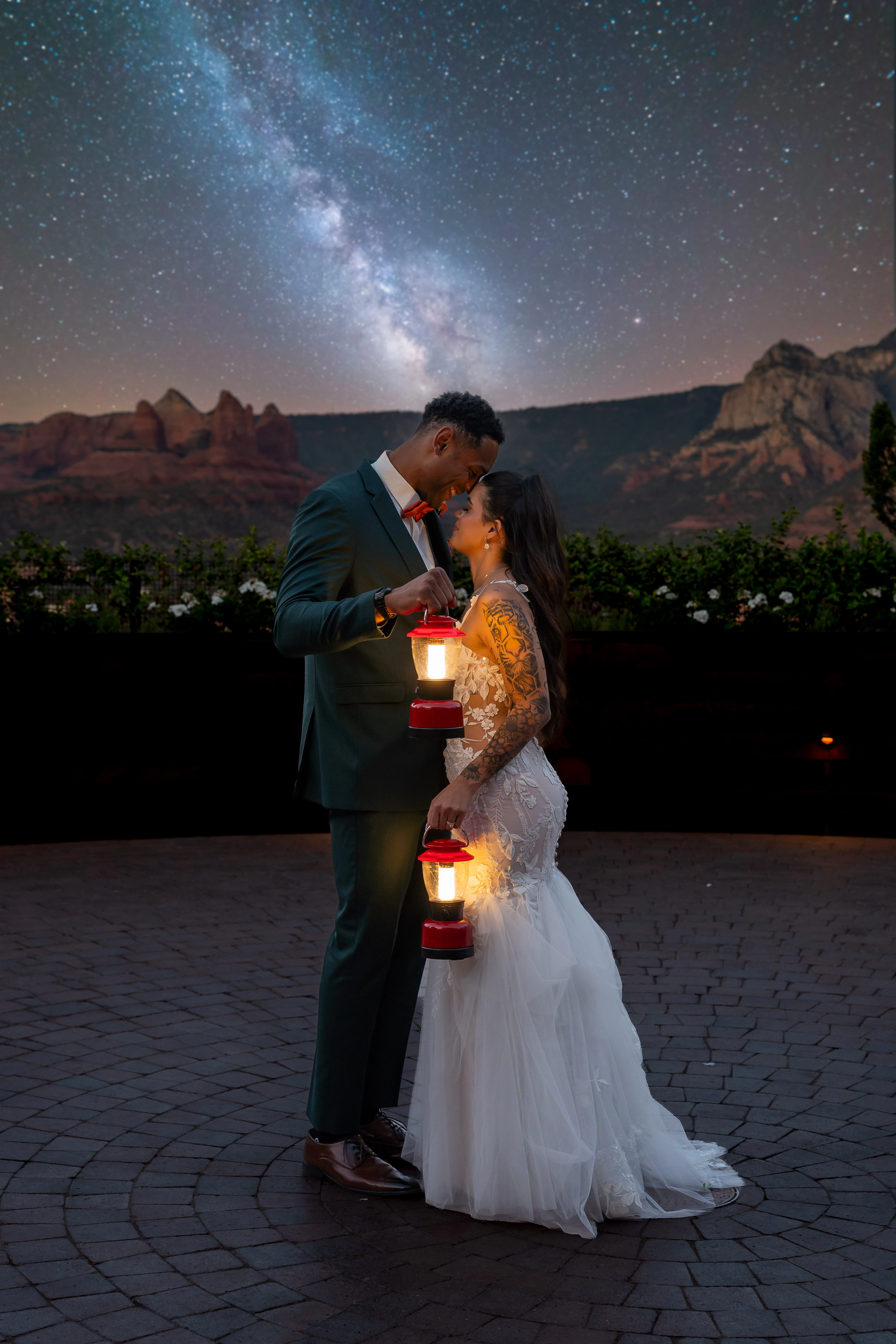 Tyreanna and Cameron holding lanterns beneath the Milky Way at their Sedona wedding